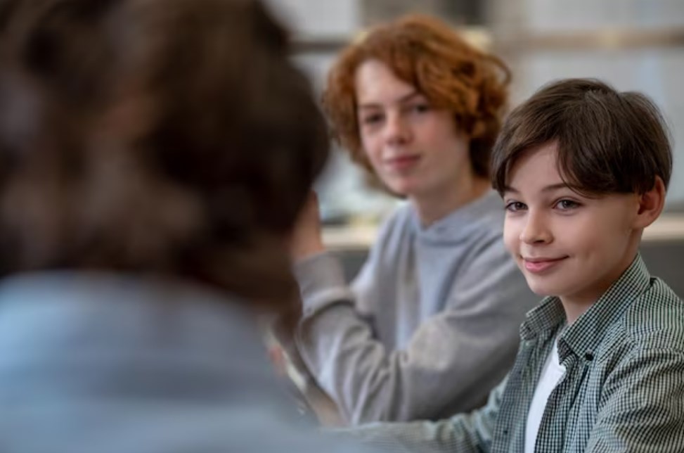 two young boys smiling and looking at an adult man