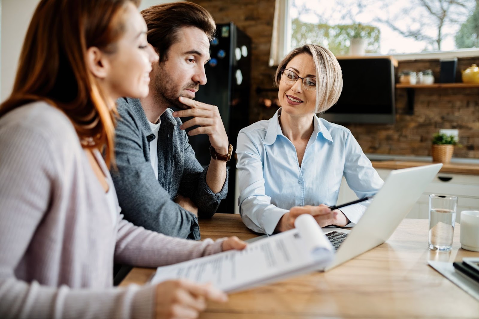 Smiling financial advisor having a meeting with young couple