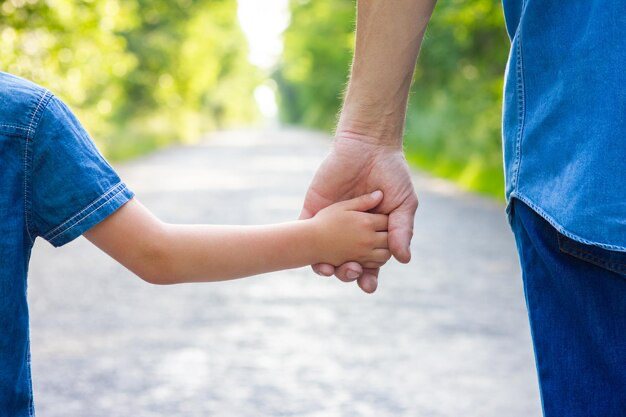 Child holding parent's hand