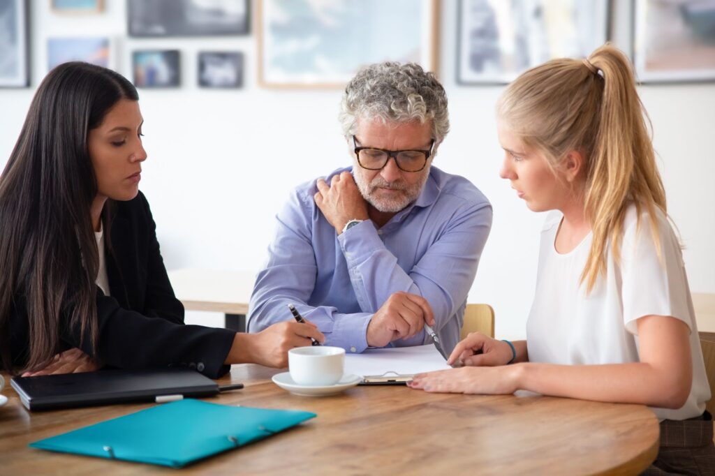 Family legal advisor explaining document details to couple